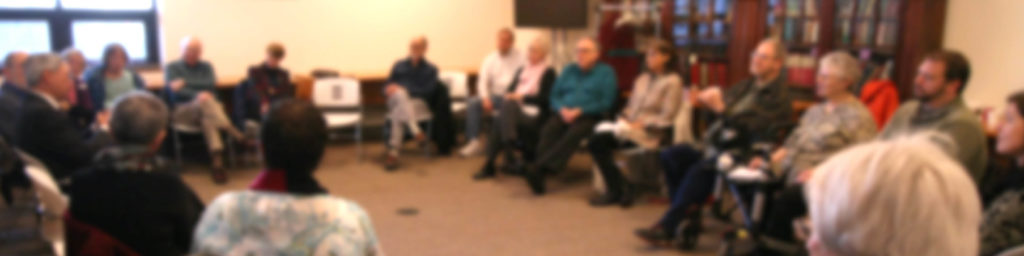 Group of adults sitting in a circle during an adult class discussion session at the church.