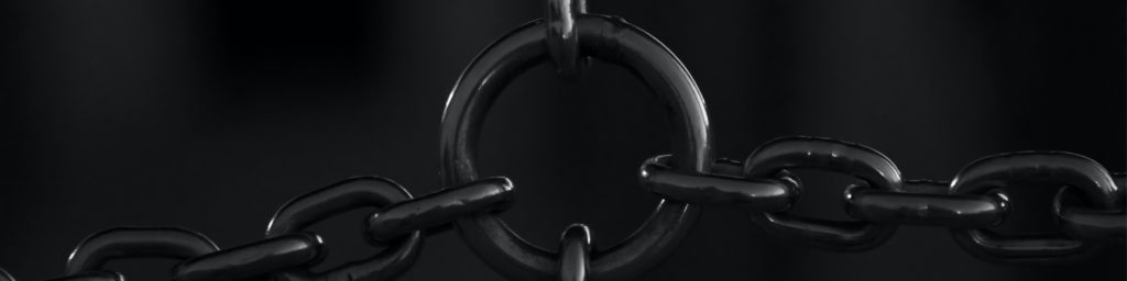 Dark atmospheric image featuring metallic chains, visual header for Pastor's Column February 2022.