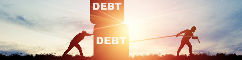 Two silhouettes pulling a block labeled 'DEBT' during sunset, representing the struggle against financial burden and debt relief efforts.