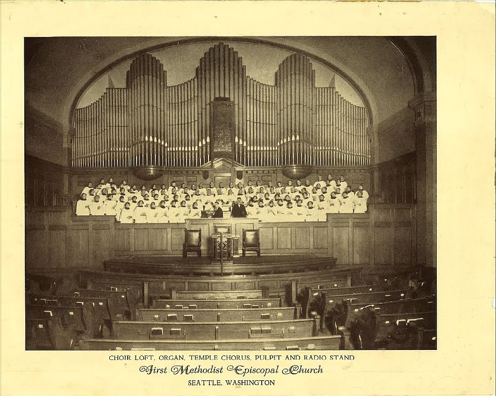 Rev. Dr. J. Ralph Magee broadcasting at a radio microphone
