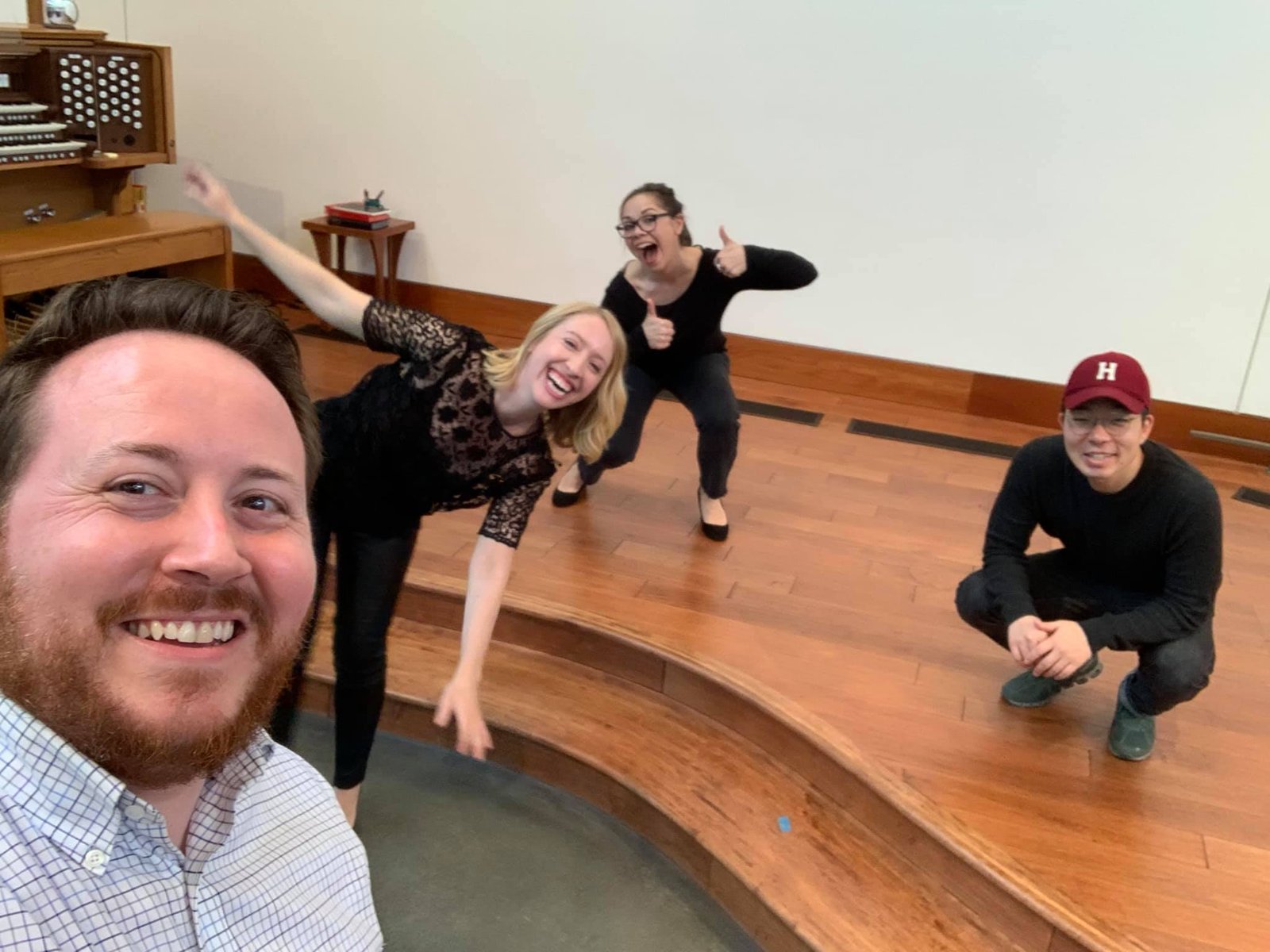 Four First Church staff members smiling after recording an online worship service