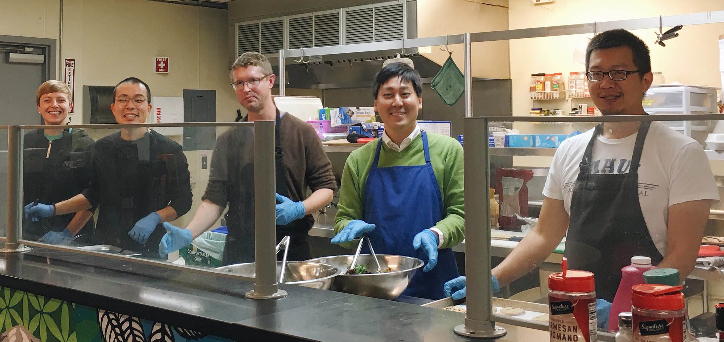 Pride and Faith volunteers preparing a One Family Dinner for residents of the Blaine Center