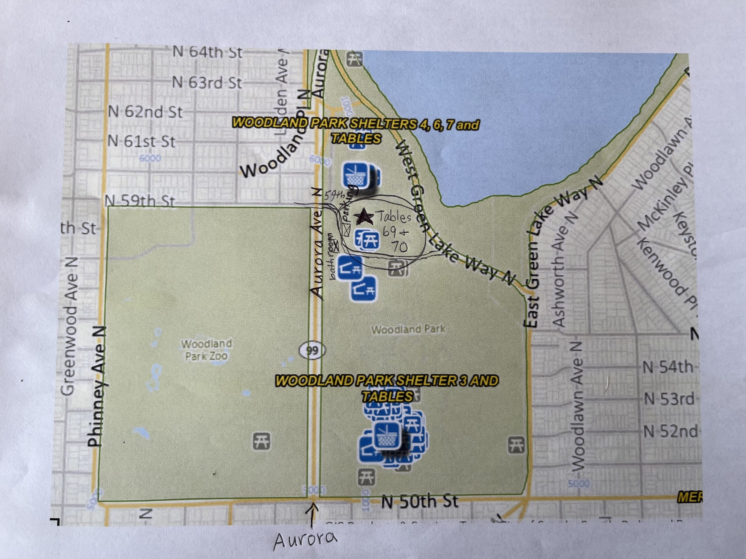 Map of Woodland Park with picnic tables 69 and 70 circled, just south of N 59th Street near West Green Lake Way North, with nearby parking and restrooms marked.