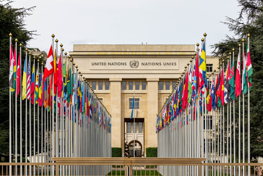 Flags of member nations line the walkway to the Palais des Nations, the United Nations Office in Geneva.